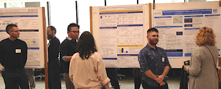 Graduate students presenting posters on their research